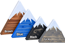 Load image into Gallery viewer, Four triangular mountain-shaped color options labeled Brown, Blue, Black, and Gray, each with a white painted peak, shown on a plain white background.