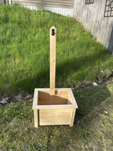 Load image into Gallery viewer, Wooden planter box with a handle on a grassy area